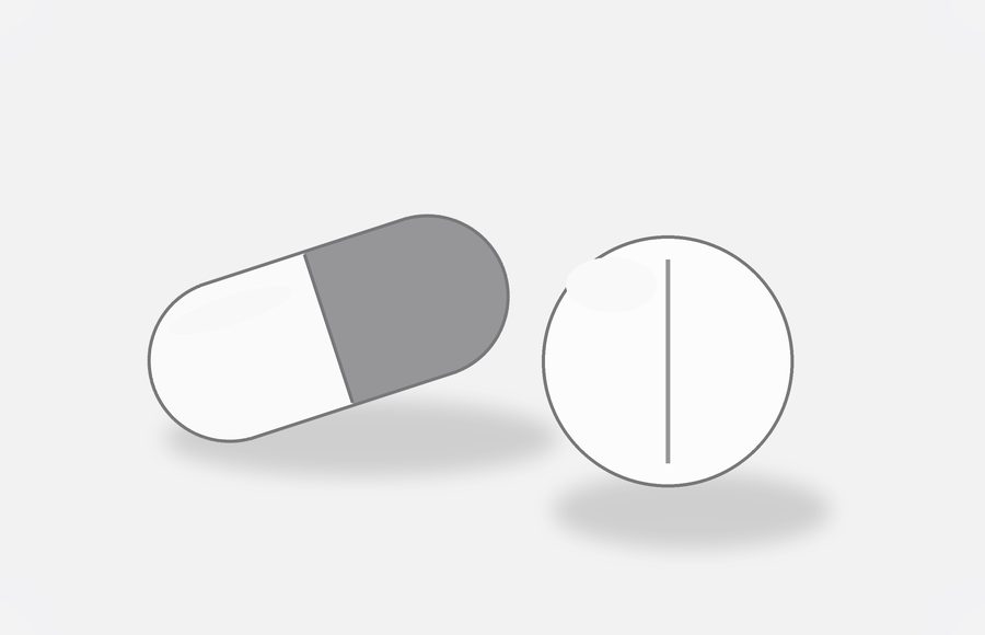 Two oral hair-loss pills — a capsule and a tablet