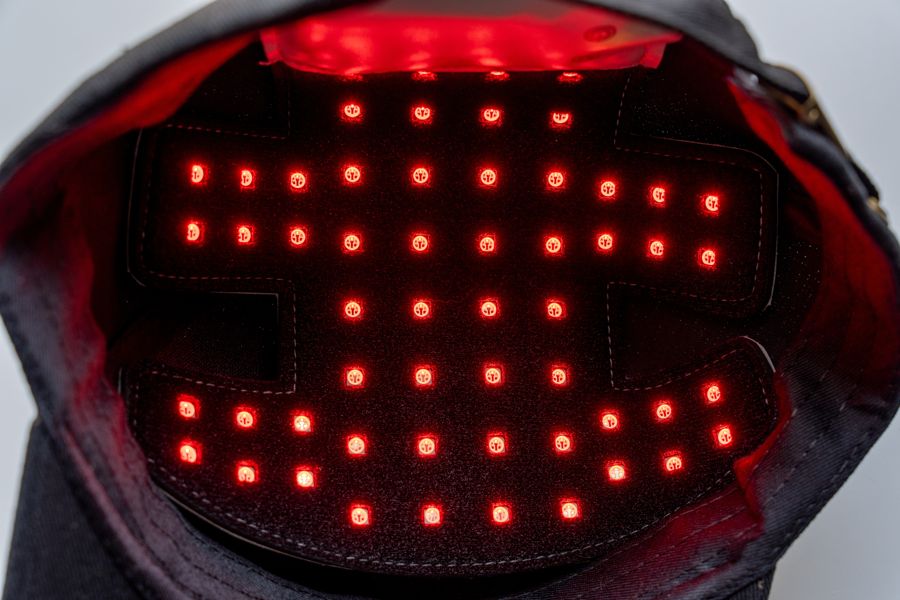 Interior of a red light therapy laser cap with LEDs illuminated